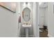 Chic powder room featuring a pedestal sink, decorative mirror, and modern fixtures at 1331 Winding Creek Way, Myrtle Beach, SC 29588