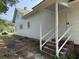 Side view of white home, featuring a back porch, brick foundation, and well-maintained yard at 1403 9Th Ave., Conway, SC 29526