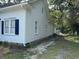 White home featuring classic design with blue shutters and lush greenery at 1403 9Th Ave., Conway, SC 29526
