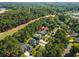 An aerial view showing the home's location near a golf course and surrounded by lush trees at 168 Mackinley Circle, Pawleys Island, SC 29585