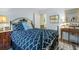 Comfortable bedroom with blue patterned bedding, side table, and view of another room at 168 Mackinley Circle, Pawleys Island, SC 29585