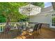Back deck featuring seating, an umbrella, and an outdoor fireplace at 168 Mackinley Circle, Pawleys Island, SC 29585