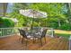 Back deck with seating, umbrella, and view to the backyard at 168 Mackinley Circle, Pawleys Island, SC 29585