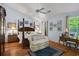Bright main bedroom with a four-poster bed, wood floors, and natural light at 168 Mackinley Circle, Pawleys Island, SC 29585