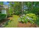 Landscaped yard with colorful hydrangeas and lush green lawn offering a serene outdoor space at 168 Mackinley Circle, Pawleys Island, SC 29585