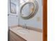 Bathroom shows a circular mirror, vanity with solid surface top and neutral decor at 1705 N Ocean Blvd. N, North Myrtle Beach, SC 29582