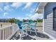 Outdoor deck area with a table and chairs overlooking tropical plants and neighborhood at 1705 N Ocean Blvd. N, North Myrtle Beach, SC 29582