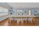 Bright dining room with stylish coastal decor, features a large table with seating for the whole Gathering at 1705 N Ocean Blvd. N, North Myrtle Beach, SC 29582