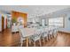 Elegant dining room featuring a large table, stylish lighting, and views into the open kitchen and living spaces at 1705 N Ocean Blvd. N, North Myrtle Beach, SC 29582