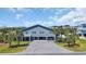 Beautiful beach house featuring ample parking, complemented by vibrant palm trees and lush greenery at 1705 N Ocean Blvd. N, North Myrtle Beach, SC 29582