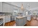 Bright kitchen with a large island, stainless steel appliances, and modern fixtures, adjacent to the dining area at 1705 N Ocean Blvd. N, North Myrtle Beach, SC 29582