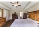 Spacious bedroom with wood floors, tray ceiling, a rustic headboard, and an ensuite bathroom at 173 Crossroad Dr. Nw, Calabash, NC 28467