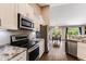 Kitchen with stainless steel appliances, granite countertops, and views of the dining area at 173 Crossroad Dr. Nw, Calabash, NC 28467