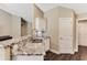 Close-up of the kitchen with granite countertops, a stainless steel sink, and white cabinets at 173 Crossroad Dr. Nw, Calabash, NC 28467