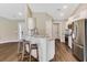 Open kitchen featuring granite countertops, a breakfast bar with stools, and stainless steel appliances at 173 Crossroad Dr. Nw, Calabash, NC 28467