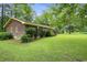 Brick house with green shrubs and trees, creating a serene setting at 1731 Lee Ln., Longs, SC 29568