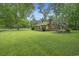 Brick house with a well-manicured lawn and mature trees at 1731 Lee Ln., Longs, SC 29568