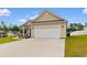 Inviting home with a two-car garage and a well-kept lawn, perfect for Gathering living at 177 Baylee Circle, Galivants Ferry, SC 29544