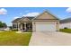 Charming single-story home featuring a two-car garage and a well-manicured front yard at 177 Baylee Circle, Galivants Ferry, SC 29544