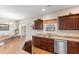 Charming kitchen featuring dark wood cabinets, tan countertops, and stainless steel appliances at 177 Baylee Circle, Galivants Ferry, SC 29544