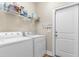 Laundry room with white washer and dryer with storage shelves at 177 Baylee Circle, Galivants Ferry, SC 29544