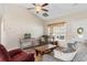 Well-lit living room featuring neutral tones, plush seating, vaulted ceiling, ceiling fan, and natural lighting at 177 Baylee Circle, Galivants Ferry, SC 29544