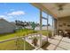 A screened-in patio with outdoor seating and a view of the spacious, well-maintained backyard at 177 Baylee Circle, Galivants Ferry, SC 29544