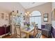 Elegant dining area with a glass-top table, decorative chandelier, and bright natural light at 1776 Starbridge Dr., Surfside Beach, SC 29575