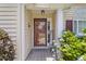 Inviting covered front porch adorned with a welcome sign and seasonal flowers at 1776 Starbridge Dr., Surfside Beach, SC 29575