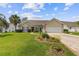 Charming single-story home with a well-manicured lawn, flower beds, and a two-car garage at 1776 Starbridge Dr., Surfside Beach, SC 29575