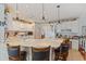 Bright kitchen features white cabinets, stone countertops, pendant lighting, and a breakfast bar with seating at 1776 Starbridge Dr., Surfside Beach, SC 29575
