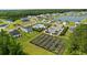 Community aerial view featuring homes, the community garden, the pool, and a scenic pond at 196 Cypress Tree Loop, Longs, SC 29568