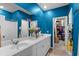 Beautiful bathroom with double sinks, large mirror, and an adjacent walk-in closet and bedroom at 196 Cypress Tree Loop, Longs, SC 29568