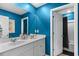 Modern bathroom with double sinks, white cabinets, and a shower/tub combo in a vibrant setting at 196 Cypress Tree Loop, Longs, SC 29568