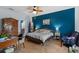 Bright bedroom featuring a wood bed frame, ceiling fan and accent wall, creating a cozy atmosphere at 196 Cypress Tree Loop, Longs, SC 29568