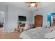 Cozy bedroom with a ceiling fan, desk, television, armoire, and hardwood floors at 196 Cypress Tree Loop, Longs, SC 29568