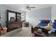 Well-lit bedroom with a large dresser, comfortable bed, and cozy chair at 196 Cypress Tree Loop, Longs, SC 29568