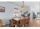 Elegant dining room featuring a large table with seating for eight, complemented by a stylish light fixture at 196 Cypress Tree Loop, Longs, SC 29568