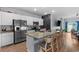 Modern kitchen with a large island, stainless steel appliances, and an adjacent living area for easy socializing at 196 Cypress Tree Loop, Longs, SC 29568