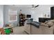 Inviting living room with cozy seating, window, black bookshelf, and modern lighting at 196 Cypress Tree Loop, Longs, SC 29568
