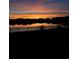 Calm pond reflecting a vibrant sunset, creating a peaceful and picturesque scene at 196 Cypress Tree Loop, Longs, SC 29568