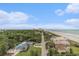 Aerial view of houses, the beach, ocean, and greenery at 201 77Th Ave. N # 1133, Myrtle Beach, SC 29572