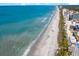 Picturesque aerial view of the coastline with a long sandy beach adjacent to turquoise waters and hotels at 201 77Th Ave. N # 1133, Myrtle Beach, SC 29572