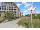 Beach access point and the 77th Avenue North sign adjacent to the building at 201 77Th Ave. N # 1133, Myrtle Beach, SC 29572