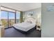 Relaxing bedroom features a balcony with an ocean view and comfortable furnishings at 201 77Th Ave. N # 1133, Myrtle Beach, SC 29572
