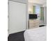 A bedroom features closet, dresser, and view of exterior buildings at 201 77Th Ave. N # 1133, Myrtle Beach, SC 29572