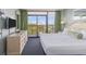 Bedroom features a TV, dresser, and balcony overlooking the ocean at 201 77Th Ave. N # 1133, Myrtle Beach, SC 29572