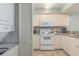 Functional kitchen with range, microwave, and stacked washer/dryer at 201 77Th Ave. N # 1133, Myrtle Beach, SC 29572