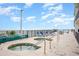 Inviting outdoor hot tubs and seating area with ocean views and bright blue skies at 201 77Th Ave. N # 1133, Myrtle Beach, SC 29572