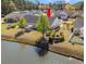 Aerial backyard view featuring a serene pond, lush landscaping, and a charming patio area for outdoor entertaining at 204 Rose Water Loop # 204, Myrtle Beach, SC 29588